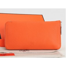 Portefeuille zippé Hermès en cuir orange original