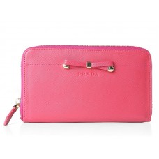 Portefeuille Prada Saffiano Zippy avec nœud décoratif rose fuchsia